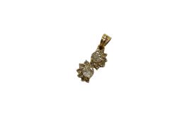 An unmarked yellow metal and two stone diamond pendant, with diamond set border, 17mm, gross