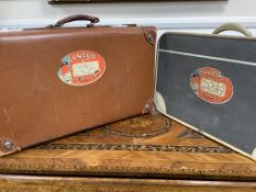 Two vintage suitcases with Cunard labels. The labels read; 1st class, Stateroom luggage, the Queen