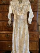 An Edwardian ladies full length summer croquet dress. Designed in a fine cream gauze, with a boned