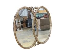 A Regency style double oval giltwood mirror, width 114cm, height 110cm