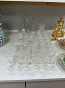 A part suite of Victorian vine engraved glasses to include two decanters and a convolvulus