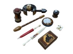 A collection of Tunbridgeware sewing items, clamp pin cushions, needle case, wax threader, tape