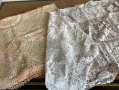 A 1920’s Normandy lace pillow sham with pink silk lining and an ornate Italian table runner with
