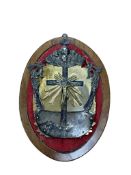 A 19th century gilt and white metal reliquary with central brass corpus on a felt lined oval