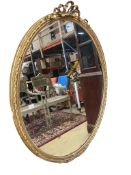 A large Victorian oval giltwood and composition wall mirror, width 106cm, height 150cm
