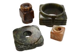 Four Chinese archaistic carved jade or hardstone congs, largest 8cm wide