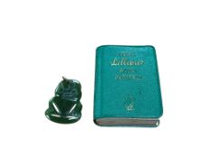 A New Zealand Tiki jade pendant, and related miniature book, Reeds Lilliput Maori Proverbs, jade