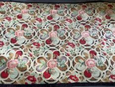 A late 19th early 20th century needle worked polychrome floral wool rug. Worked with a repeating