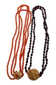 A twin strand facet cut garnet bead necklace with filigree yellow metal clasp, 38cm, together with a