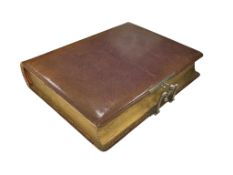 A late Victorian tan leather photograph album containing monochrome portrait cards, height 27cm