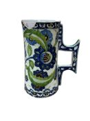 A Cantagalli pottery tankard, decorated in the Iznik style, 22cm high.