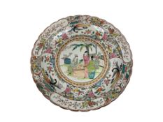 A Japanese porcelain charger, decorated in polychrome enamels with figures, birds and flowering