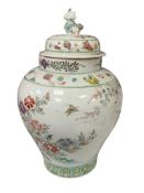 A 19th century Japanese porcelain baluster vase and cover decorated with birds among peoney,