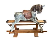 An early 20th century grey- painted rocking horse, without maker’s mark, 133cm long, 110cm high to