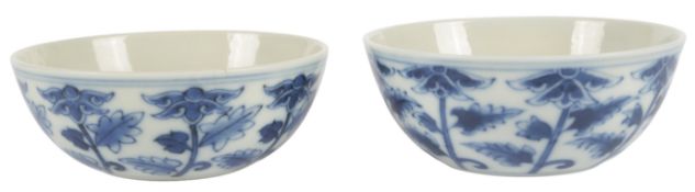 A pair of Chinese blue and white floral decorated cups, 8cm in diameter