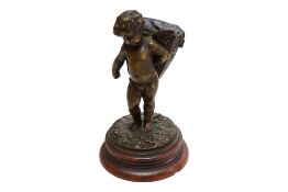 After Louis Kley (French, 1833-1911), a patinated bronze of a cherub, raised on a rouge marble base,