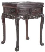 A Chinese carved hongmu envelope card table, c.1900, the folding segmented top carved in high relief