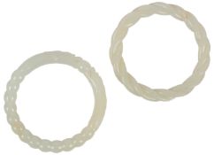 Two Chinese white jade bangles, 19th/20th century, the first carved with a rope twist design,