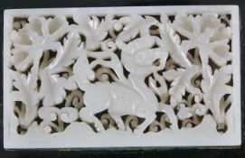 A Chinese pale celadon jade ‘qilin’ plaque, 17th century, mounted on a Japanese green enamelled