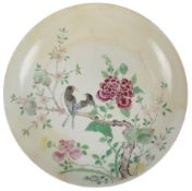 A Chinese famille rose dish, Yongzheng period (1723-35), painted with two birds perched on a