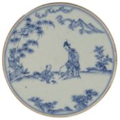 A Chinese blue and white circular plaque, in Ming style, painted with a lady and a boy in a garden