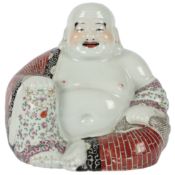 A large Chinese enamelled porcelain seated figure of Budai, mid 20th century, wearing floral and