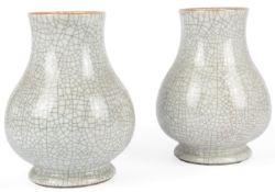 A pair of Chinese crackle glaze pear-shaped vases, 19th/20th century, each on a circular spreading