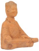 A Chinese terracotta kneeling figure of a musician, probably Han dynasty, modelled as a seated