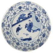A Chinese blue and white 'scholar and boy' dish, Kangxi mark and of the period (1662-1722),