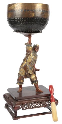A large Japanese bronze figure of Benkei holding aloft a bell, in Miyao style, Meiji period, the