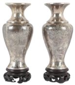 A pair of Chinese white metal vases and integral wood stands, early 20th century, each engraved a
