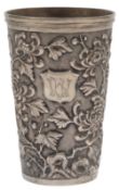A Chinese Straits repousse white metal beaker, decorated with scrolling foliage, signed on the base,