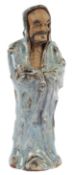 A large Chinese Shiwan pottery figure of a Bodhidharma, late 19th/early 20th century, his robes with