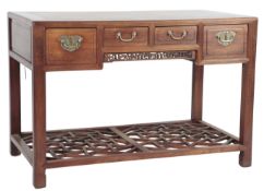 A Chinese hongmu scholar’s desk, mid 19th century, fitted with four drawers, two with butterfly
