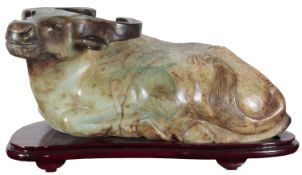 A massive Chinese bowenite jade figure of a recumbent buffalo, late 20th century, the green stone