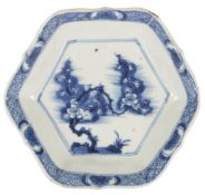 An unusual Chinese blue and white hexagonal saucer dish, Kangxi period, painted to the centre with a