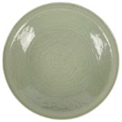 A large Chinese Ming Longquan carved celadon ‘Phoenix and dragon’ dish, 16th century, the central