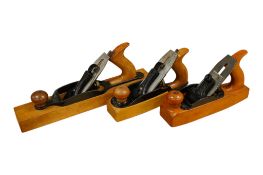 Three Stanley Bailey transitional wood bottom planes; a No.26 jack plane, and two variants of the No