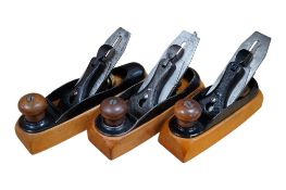A set of three graduated Stanley wood bottom transitional Smooth Planes; a No.21, a No.22, and a No.