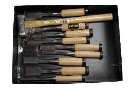 A set of nine Japanese bevel edge chisels and mortise chisels, together with a Japanese 225g mallet