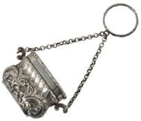 A William IV novelty silver vinaigrette, modelled as a handbag, the hinged cover decorated with a sc