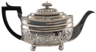 A George III silver teapot, with later embossed decoration, by William Knight II