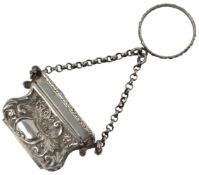 A Victorian novelty silver vinaigrette, modelled as a handbag and hinged cover decorated with a scen