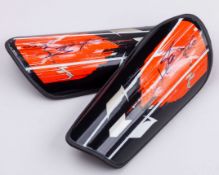 A pair of Lionel Messi autographed black and orange Adidas Messi Club shin pads