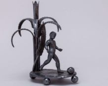 A Victorian white-metal glass posy holder modelled as a footballer&nbsp;