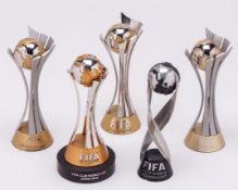 Five FIFA miniature trophies