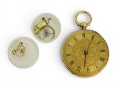 An 18ct gold open face fob watch with a decorative yellow metal dial, inner dust cover metal,