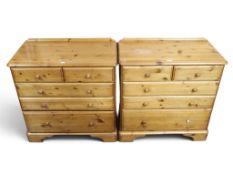 A pair of 20th century Ducal stained pine bedroom chests each with two short over three long drawers