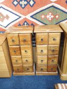 A pair of early 21st century mango wood chests of drawers each with four rows over two drawers