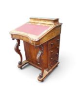 A Victorian burr walnut veneered Davenport writing desk with raised stationary compartment over